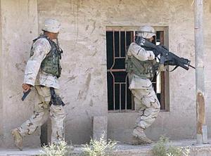  Soldiers of the 115th Military Police Company secure a building during a house-to-house search for weapons, outside of Falluja, Iraq. ula1 