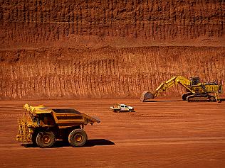 Machinery operates in a pit at Rio Tinto Group's West Angelas iron ore mine in Pilbara, Australia, on Sunday, Feb. 19, 2012. Rio Tinto Group, the world's second-biggest iron ore exporter, will spend $518 million on the first driverless long-distance trains to haul the commodity from its Western Australia mines to ports, boosting efficiency. Photographer: Ian Waldie/Bloomberg