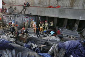 Rescue workers search for survivors after an explosion at a subway construction site in Namyangju, South Korea, Wednesday, June 1, 2016.