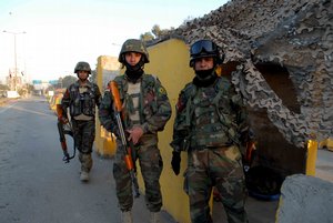 People in the Green Zone checkpoint with Iraqi solider