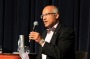 Opportunities for Personalised Transport Review Taskforce chair Jim Varghese on stage at a public forum on the issue in ...