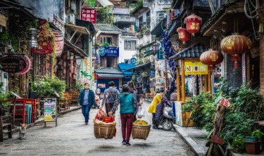 Even in modern day Yangshuo, China, the ancient ways are the most efficient. Here a lady is moving a huge basket of ...