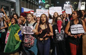 Women march during a protest against the gang rape of a 16-year-old girl in Sao Paulo, Brazil, Wednesday, June 1, 2016.