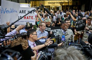 U.S. Army vet Claude Copeland, center, "is joined by protesting veterans, as he speaks during a press briefing outside a Donald Trump press conference, Tuesday May 31, 2016, in New York.