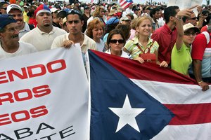 Puerto Rican workers participate in a protest rally, days before the local government has announced it may be forced to temporarily shutdown public schools and other departments due to a more than US$700 million shortfall in public funds, in front of the Capitolio building, in San Juan, Puerto Rico, Thursday, April 27, 2006.