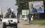 UN forces drive past a billboard for President Laurent Gbagbo in, Ivory Coast, Abidjan Thursday, Dec. 23, 2010. The United Nations said Thursday that at least 173 people have been killed and dozens of others have gone missing or been tortured following Ivory Coast's disputed presidential election, which has prompted fears of a return to civil war.