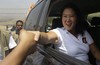 Presidential candidate Keiko Fujimori, of the "Fuerza Popular" political party, greets supporters as she campaigns in the Cajamarquilla shantytown on the outskirts of Lima, Peru, Wednesday, March 30, 2016.