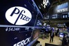 File-This April 6, 2016, file photo shows the Pfizer logo appearing on a screen above its trading post on the floor of the New York Stock Exchange.