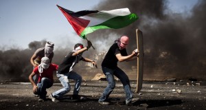 Demonstrators bearing a  Palestinian flag (photo credit 972 magazine)