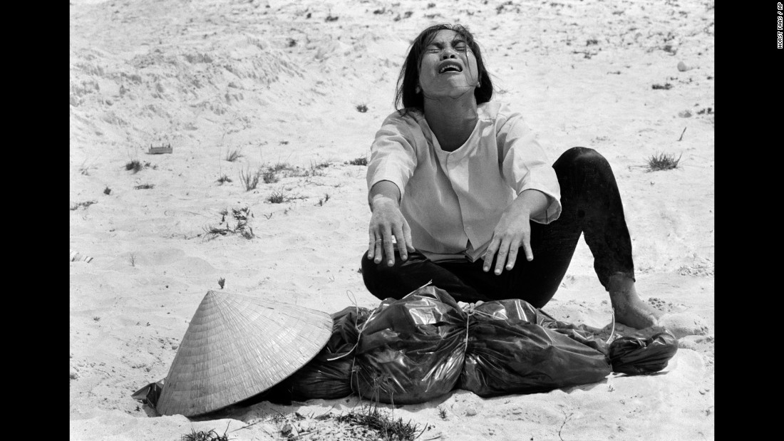 A South Vietnamese woman mourns over the body of her husband, which was found with 47 others in a mass grave near Hue in April 1969.