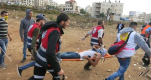 Medic rush to evacuate the injured at a demonstration near the Beit El settlement.