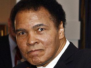 08/04/2006 LIBRARY: 08/04/2006 LIBRARY: Former heavyweight boxing champion Muhammad Ali gestures for photographers in a hotel on the sidelines of the World Economic Forum WEF in Davos, Switzerland. (AP Photo/Laurent Gillieron, Keystone)