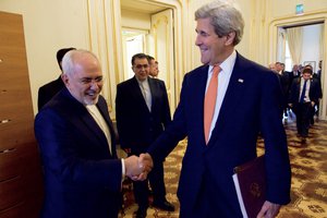 File - U.S. Secretary of State John Kerry and Iranian Foreign Minister Javad Zarif share a laugh on May 17, 2016, as they enter the Blue Salon at the Palais Coburg Hotel in Vienna, Austria, the same room where they negotiated the Iranian nuclear deal, to have further conversations about the implementation of the Joint Comprehensive Plan of Action.