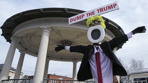 An effigy with a "Dump the Trump" sign is posted at a bandstand outside Exeter Town Hall, a campaign stop for Republican presidential candidate Donald Trump, in Exeter, N.H., Thursday, Feb. 4, 2016.