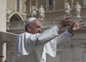 Pope Francis uses sign language to salute a group of deaf pilgrims as he arrives for his weekly general audience in St. Peter's Square at the Vatican, Wednesday, May 25, 2016.