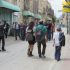 The delegation on Shuhada Street, with Shuada checkpoint in the background and a group of settlers passing them