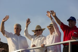 File - Cuba's Vice President Miguel Diaz-Canel, left, Cuba's President Raul Castro, center, Cuba's Vice President Jose Ramon Machado Ventura, second right, and Workers' Union chief Ulises Guilart, right, wave as they watch the May Day parade at Revolution Square, in Havana, Cuba, Sunday, May 1, 2016.