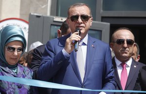 From left to right; Turkey's First Lady Emine Erdogan, Turkey's President Recep Tayyip Erdogan, and Turkey's Foreign Minister Mevlut Cavusoglu attend a ceremony to open a new Turkish embassy in Mogadishu, Somalia Friday, June 3, 2016.