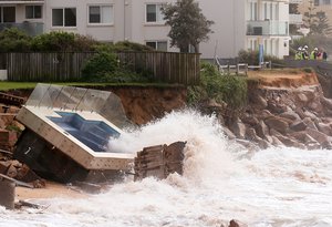 A swimming pool is dislodged and lays on a beach after storms undermined the pilings at Collaroy Beach in Sydney, Monday, June 6, 2016. Storms have lashed Australia's easter coast for several days. (AP Photo/Rick Rycroft)