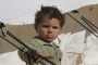 A child plays around a temporary refugee camp for displaced Syrians in northern Syria.