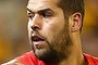 Sydney's Lance Franklin of the Swans attempts to avoid a tackle by Hawthorn's Ben Stratton on Friday night.