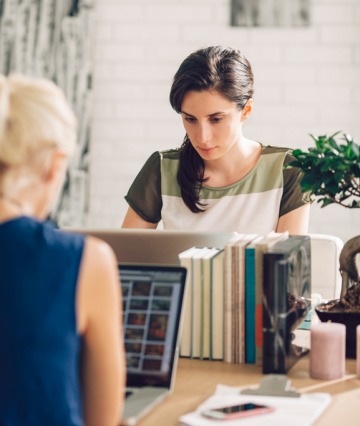 Two businesswomen working in the same office.