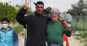 A Palestinian man and a Israeli man stand together in opposition to occupation