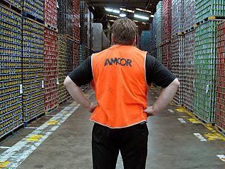 An Amcor Ltd. employee looks down an aisle of stacked aluminum beverage cans ready for distribution at the company's beverage can production facility in Melbourne, Australia, on Tuesday, Feb. 19, 2008. Amcor Ltd., Australia's biggest packaging company, are expected to post first-half earnings on Feb. 20. Photographer: Carla Gottgens/Bloomberg News