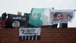 Kashmiri Muslim protesters hold (L-R) Islamic State (IS), Lashkar-e-Toiba, Pakistan flags and poster of IS chief Abu Bakr Al Baghdadi during a protest after Friday prayers outside Kashmir’s grand mosque at Jamia Masjid in Srinagar, summer capital of Indian Kashmir, 21 August 2015. The talks between Indian and Pakistan National Security Advisors (NSA) scheduled on August 23 are at risk, following India’s hardening of stand against Pakistan for inviting Kashmiri separatist leaders for meeting its NSA Sartaj Aziz in Indian capital before his meeting with his Indian counterpart Ajit Doval.