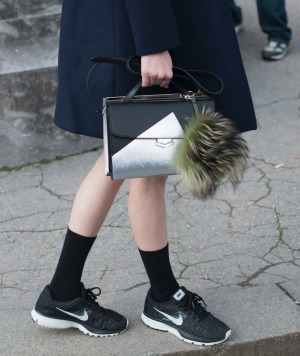 Model Ming Xi wears Celine coat, Fendi bag and Nike trainers.