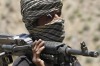 A member of a breakaway faction of the Taliban fighters guards a gathering in Shindand district of Herat province, ...