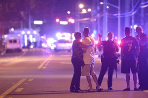 Orlando Police officers direct family members away from a multiple shooting at a nightclub in Orlando, Fla., Sunday, June 12, 2016