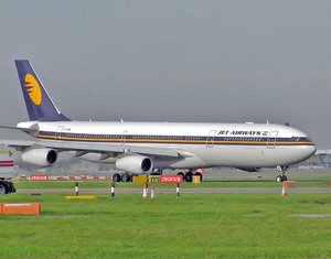 Jet Airways Airbus A340-300 (VT-JWB) waiting for take off, with engines running, at London Heathrow Airport.