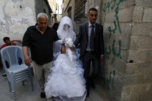 Palestinians celebrate during a wedding . Around young Palestinians Participated in the wedding.  in Gaza City on Jun 16, 2012. Photo by Ahmed Deeb/WN