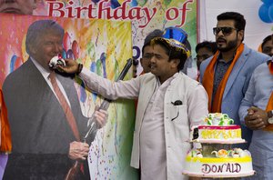 Members of the Hindu nationalist party 'Hindu Sena' or Hindu Army, celebrate the birthday of U.S. presidential candidate Donald Trump in New Delhi, India, Tuesday, June 14, 2016.