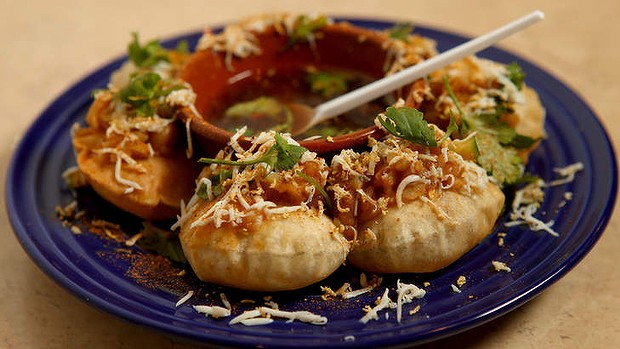 Street snacks: Fuchka - chickpea flour pastries filled with yellow lentil dhal, egg, cucumber and tamarind sauce.