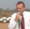 Tony Abbott bites in to a member of the onion family, possibly a spring onion, at a Queensland onion farm in 2011.