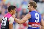 MELBOURNE, AUSTRALIA - MAY 15:  Jake Stringer of the Bulldogs (R) grapples with Neville Jetta of the Demons during the round eight AFL match between the Melbourne Demons and the Western Bulldogs at Melbourne Cricket Ground on May 15, 2016 in Melbourne, Australia.  (Photo by Michael Dodge/Getty Images)