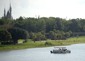 Orange County Sheriff's officers search the Seven Seas Lagoon between Walt Disney World's Magic Kingdom theme park, left, and the Grand Floridian Resort & Spa Wednesday, June 15, 2016, in Lake Buena Vista, Fla., after a two-year-old toddler was dragged into the lake by an alligator. (AP Photo/Phelan M. Ebenhack)