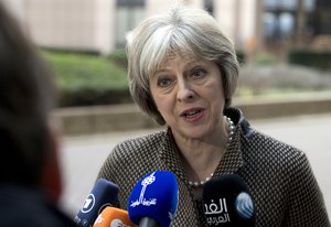 In this file photo dated Thursday, March 10, 2016, British Home Secretary Theresa May speaks with the media as she arrives for a meeting of EU justice and interior ministers at the EU Council building in Brussels.