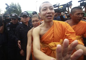 Department of Special Investigation officers and monks negotiate with temple authorities as they serve an arrest warrant at Wat Phra Dhammakaya temple in Pathum Thani province, north of Bangkok, Thailand, Thursday, June 16, 2016.