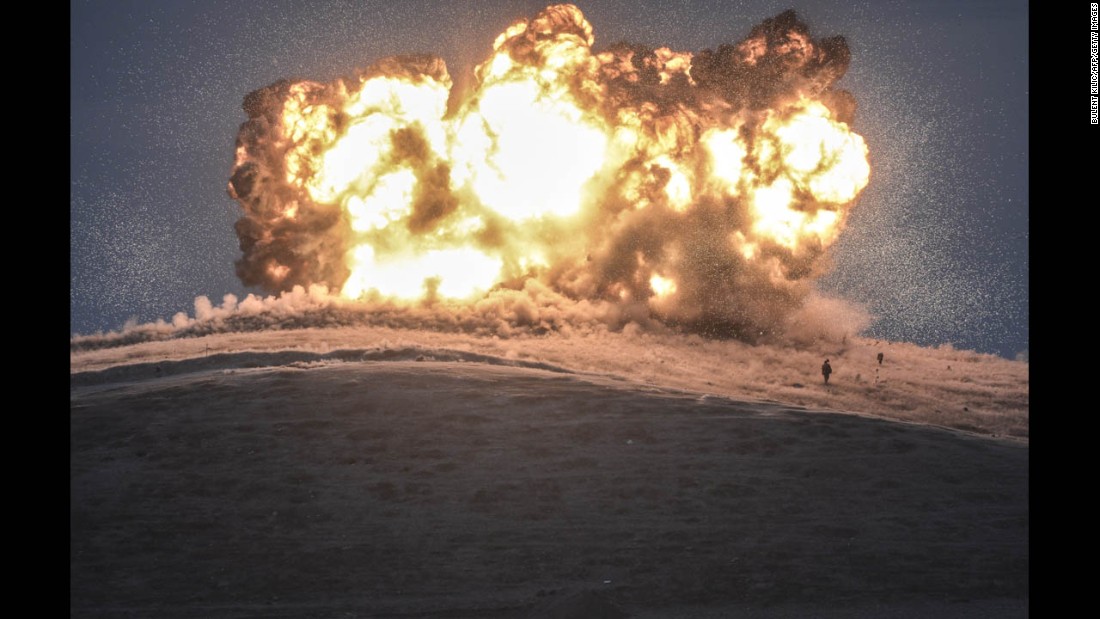 ISIS militants stand near the site of an airstrike near the Turkey-Syria border on Thursday, October 23. The United States and several Arab nations have been bombing ISIS targets in Syria to take out the militant group&#39;s ability to command, train and resupply its fighters.