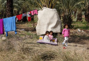 Iraqi internally displaced children play at a camp for internally displaced persons in Youssifiyah, 12 miles (20 kilometers) south of Baghdad, Iraq, Tuesday, Feb. 23, 2016.