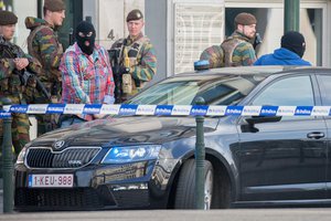 Police officers guard the entrance as a car arrives at the federal court building in Brussels on Thursday, June 9, 2016. A Belgian judge will decide Thursday whether to satisfy a French request to extradite Mohamed Abrini, a suspect in the Brussels Airport bombing.