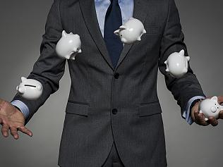 Businessman juggling piggy banks