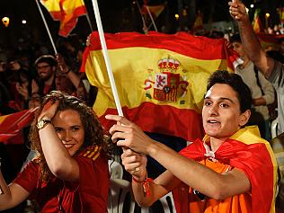 Ciudadanos (Citizens) political party's supporters wave Spanish flag as they celebrate the victory oftheir team at the end of the match between Spain and Turkey during the Euro 2016 in Barcelona on June 17, 2016. / AFP PHOTO / PAU BARRENA