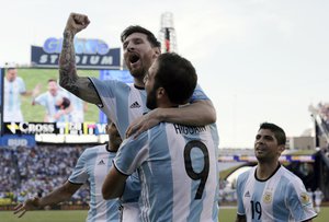 Argentina's Lionel Messi, top, celebrates a goal by Gonzalo Higuain (9) during the first half of a Copa America Centenario quarterfinal soccer match against Venezuela on Saturday, June 18, 2016, in Foxborough, Mass.