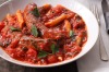 Greek sausages in tomato and caper stew. Jill Dupleix SAUSAGES recipes for Epicure and Good Living. Photographed by ...