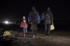 A family of refugees walks through the night to reach the Macedonia-Serbia border. 