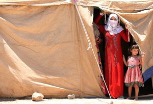 Internally displaced Iraqis at a camp outside Fallujah, Iraq, Monday, June 14, 2016. The U.N. estimates about 50,000 civilians are trapped inside the city and that 42,000 have recently fled.